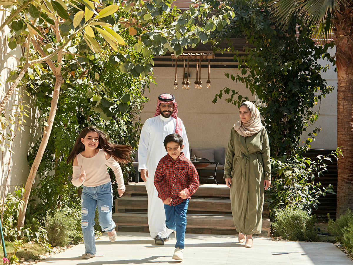 Middle Eastern family walking outside 