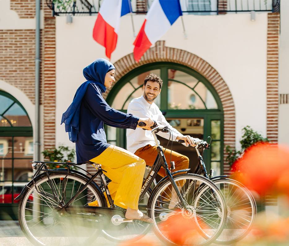 Couple riding bikes round the Paris resort